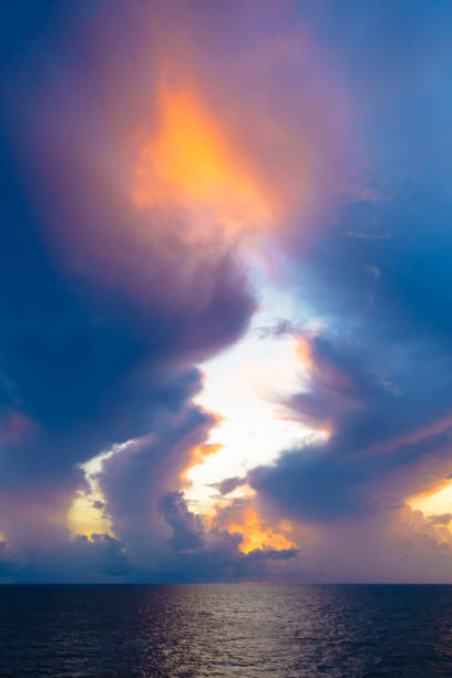 istock Fiery orange sunset sky warm light with clouds and sea, Beautiful for background. 812295628