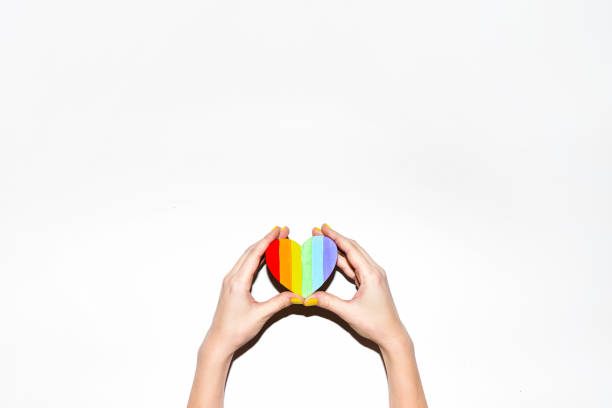 istock Rainbow gay pride symbol heart shaped in hands on white 812300700