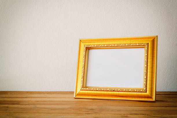 istock Gold photo frame on wooden 812308170