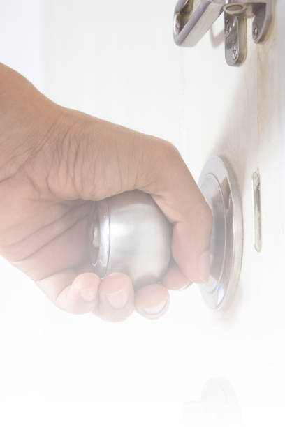 istock Hand on aluminum door knob to open 812314958
