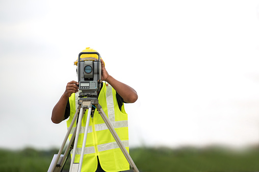 survey engineer in construction site use theodolite mark a concrete pile co ordinate