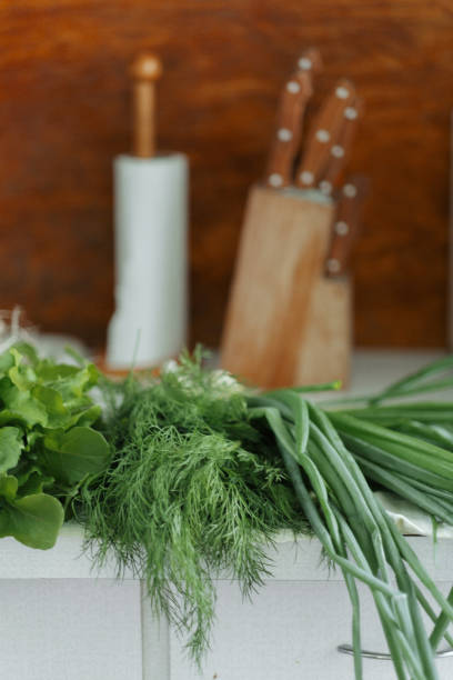 istock Fresh bunch of organic greenery on the kitchen table top 812325336