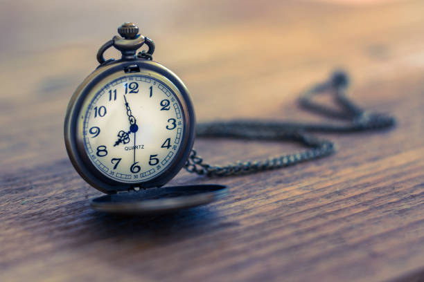 istock pocket watch on the old wooden table with copy space, concept time and work 812327934