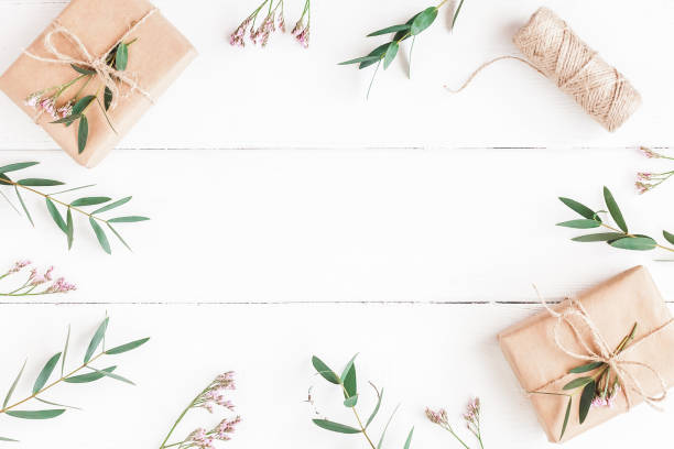 istock Gifts, pink flowers and eucalyptus branches. Flat lay, top view 812339786