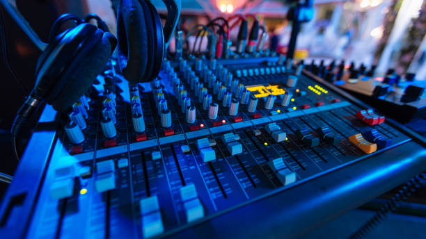 istock Professional audio mixing console with fader and adjusting knobs - radio / TV broadcasting that hand adjusting audio mixer 812350906