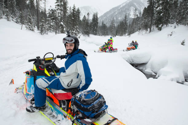 istock Snowboard snowmobile tow in magic snow forest. 812370982
