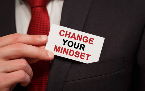 istock Businessman putting a card with text Change Your Mindset in the pocket 812371444
