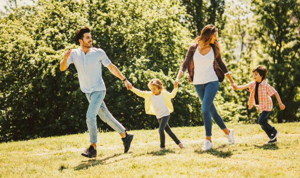 istock Happy family running in the park 812375974