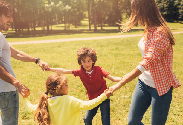 istock Happy family spinning in the park 812375996