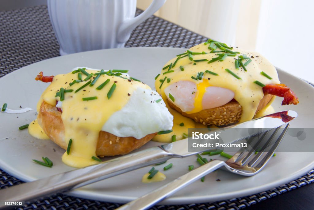 Eggs Benedict. Eggs Benedict. Toasted muffins, ham, poached eggs, and delicious buttery hollandaise sauce Egg - Food Stock Photo