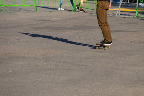 istock Skateboarder legs riding skateboard at skatepark 812381390