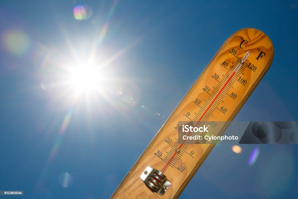 Mercury thermometer Summer heat Sun light Mercury thermometer marking 41 degrees Celsius 106 Fahrenheit in a sunny day. Summer heat shown on mercury thermometer against the blue sky. Sunlight with sun flares. Heat - Temperature Stock Photo