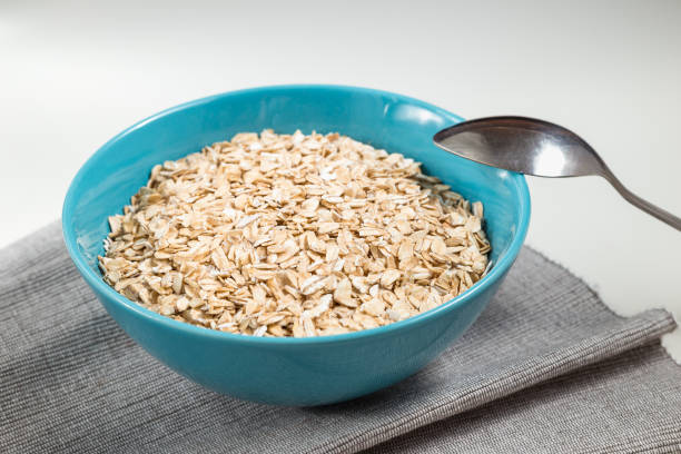 istock Oat flakes in blue bowl ready to cook 812392788