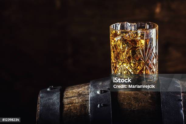 Whiskey Drink Glass Of Whiskey On Old Wooden Barrel Stock Photo - Download Image Now