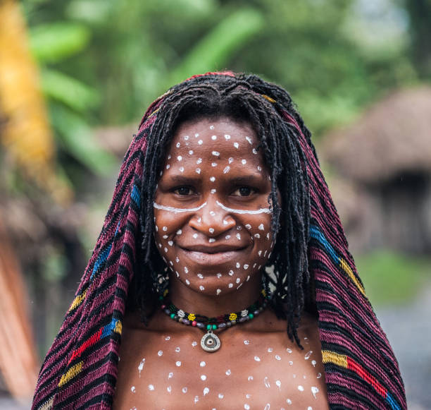 Portrait of Woman Dani tribe in ritual coloring on the body and face. stock photo