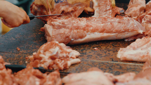 istock Butcher's row. Butcher cutting meat on the stall 812405008