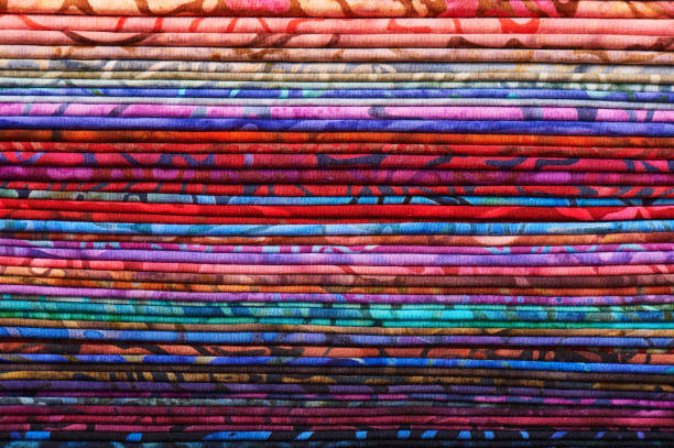 Stack of colorful batik fabrics as a vibrant background image