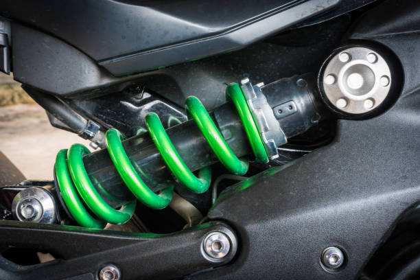 istock Modern motorcycle shock absorber a device for absorbing jolts and vibrations, especially on a motor vehicle with stain from raindrop. Select focus 812407752