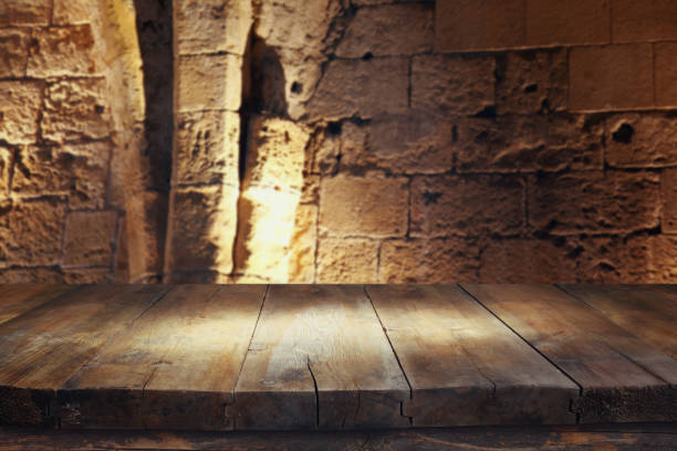 istock Empty old table in front of ancient knight stone tower. Useful for product display montage 812408064