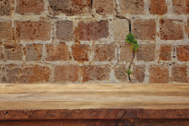istock Empty old table in front of ancient wall of stones. Useful for product display montage 812408102