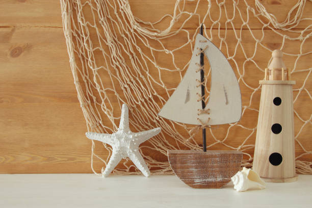 istock Nautical concept with sea life style objects on wooden table. 812408174