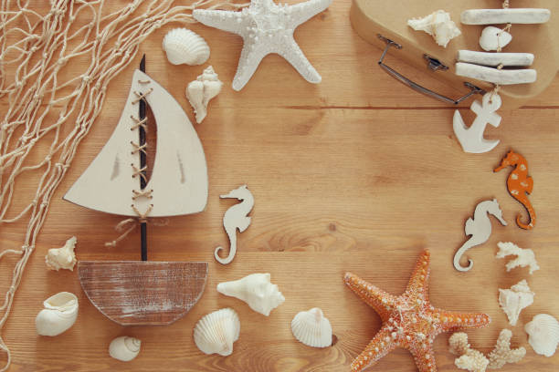 istock Nautical concept with sea life style objects on wooden table. Top view 812408440
