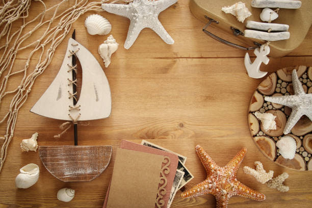 istock Nautical concept with sea life style objects on wooden table. 812408472