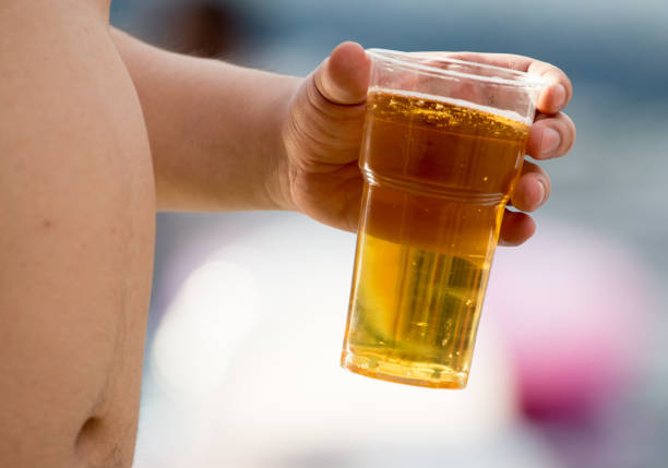 istock Beer in a plastic glass is drinking a man 812416608