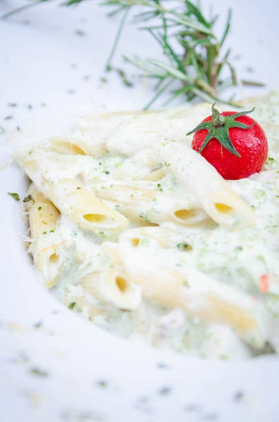 Penne pasta with cherry tomato closeup