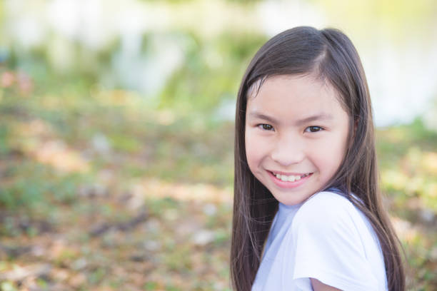 istock Young girl sitting in park 812425932