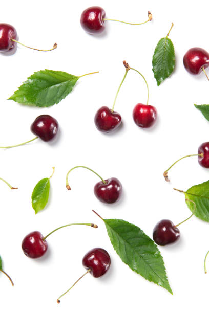 istock Ripe cherry berries and cherry leaves pattern isolated on white background, top view 812426224