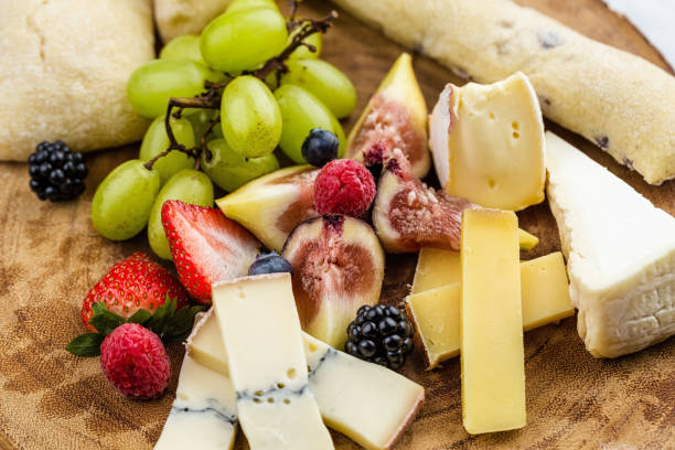istock Cheese plate with bread grapes and strawberries 812432652