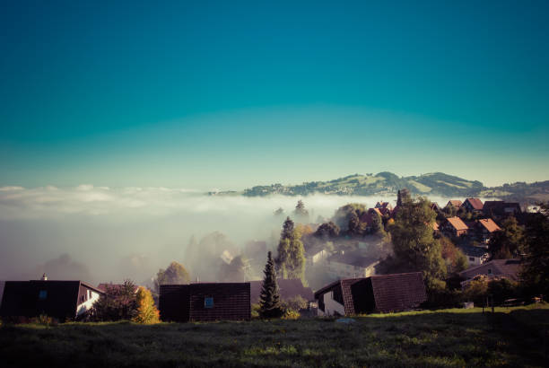 istock Mountain village in clouds 812434726