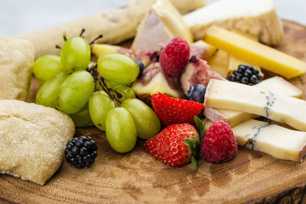 istock Cheese plate with bread grapes and strawberries 812434742