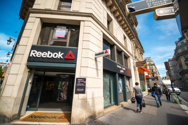 Reebok Store in Paris city center, France Paris, France - May 12, 2017: Reebok Store in Paris city center with people walking on the streets. reebok stock pictures, royalty-free photos & images