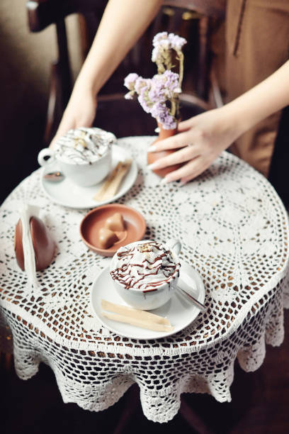 istock Bride and groom coffee break dating gift, bouquet on table. 812446546