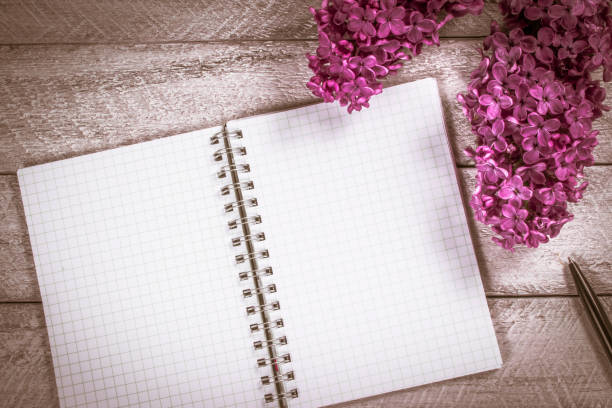 istock flowers on wooden table. copy space. workspace with notebook. celebration template concept. 812446632