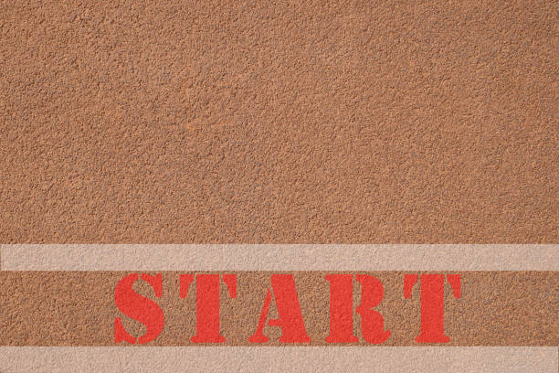Red start text written on road with copy space for text. Concept of plan, target, goal, begin.