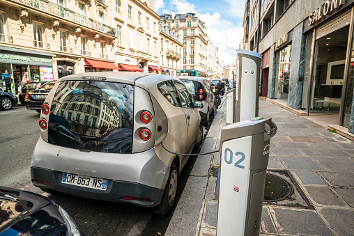 Paris, France - May 12, 2017:  Electric Car Charging on Paris Street, there is a lot of places for charging electric cars in Paris, as those cars becoming more and more popular