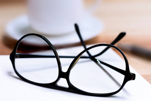 istock Glasses and cup of coffee on wooden table. 812451438