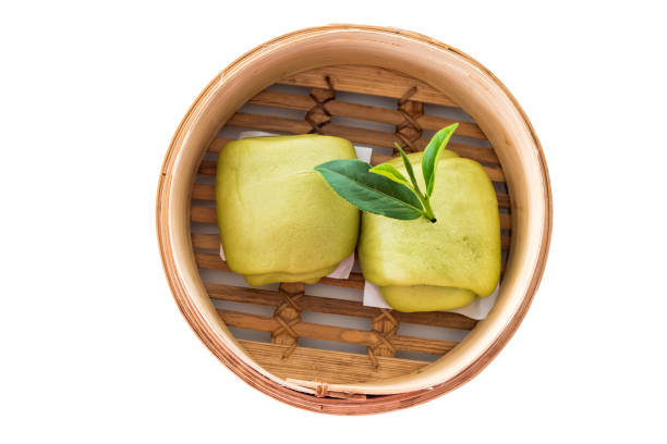 istock Steamed bun and green tea leaves isolated on white background. clipping path 812452134