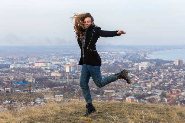 istock Girl jumping city 812452162