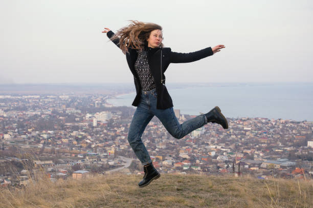 istock Woman jump landscape 812454370
