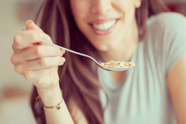 istock Young  woman breakfast cereals in the kitchen 812454536