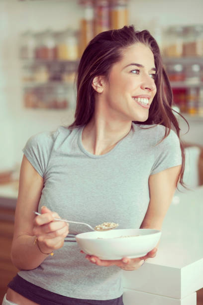istock Young  woman breakfast cereals in the kitchen 812454710