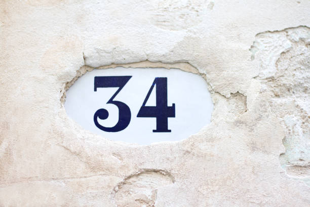 istock Number 34 Street Address Tile On Old White Wall 812457072