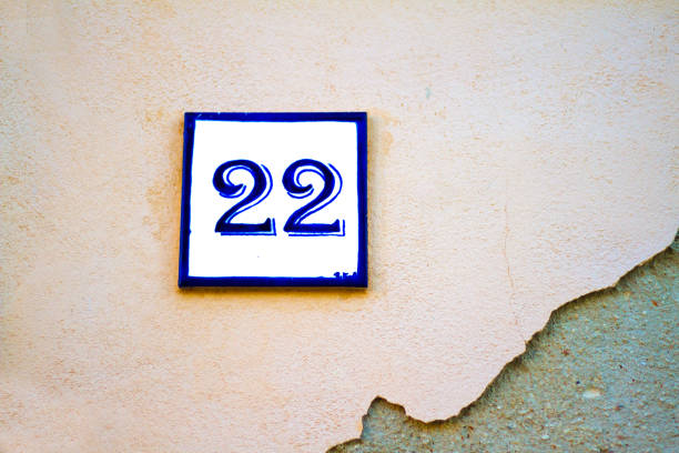 istock Number 22 Street Address Tile On Pale Pink Wall 812457154