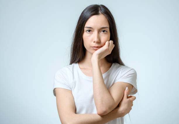 istock Beautiful young confident woman with serious expression isolated on gray 812460620