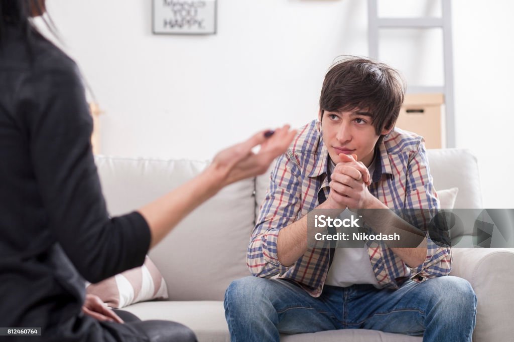 Boy teenager at a psychologist Boy teenager at a psychologist at the office's Teenager Stock Photo