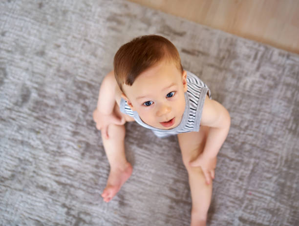 istock Cute baby is looking to camera 812463396